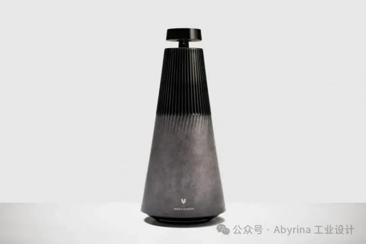 A cone-shaped black and gray Bang & Olufsen speaker with a ribbed upper section and the logo at the bottom, set against a plain light background.