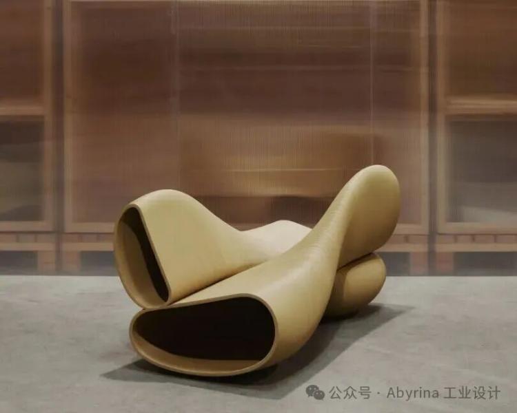 A sculptural, tan-colored bench with a twisting, wave-like design is positioned on a concrete floor