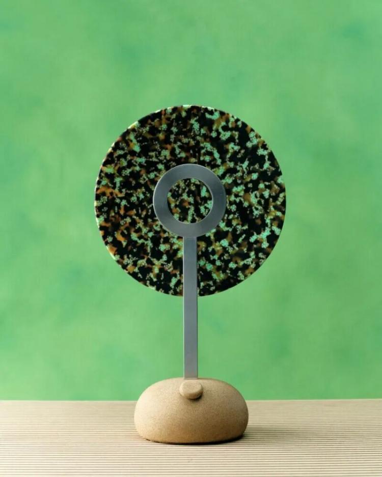 table lamp with bright colorful reflector and green background